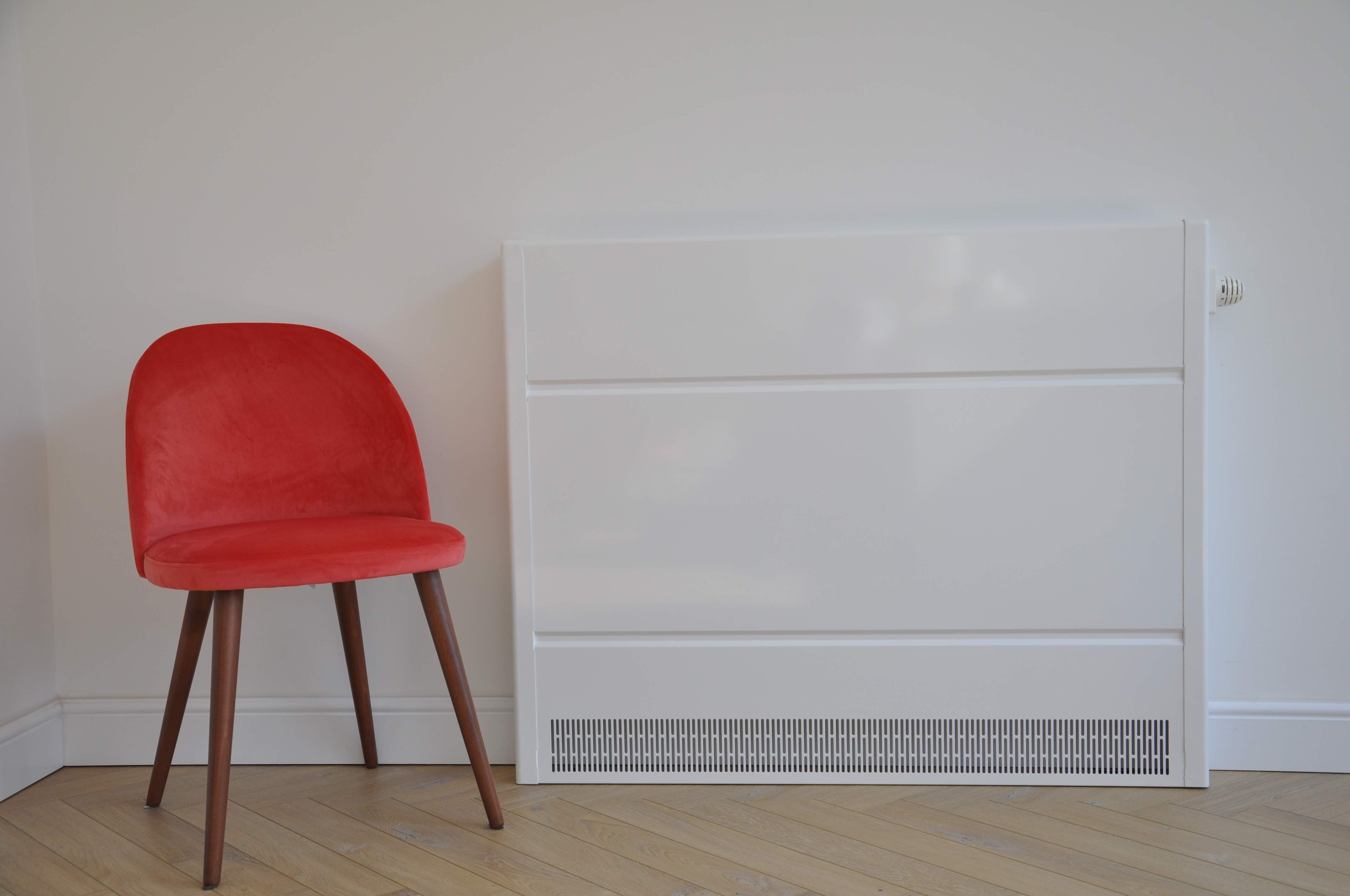 covora lite lst radiator next to a red chair