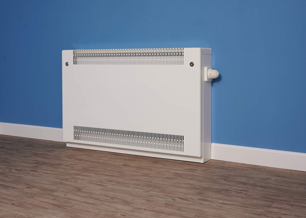 a-flat-top-floor-mounted-lst-radiator-against-a-blue-wall